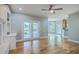Bright living room with hardwood floors, ceiling fan, and French doors to the outside at 8795 E Fairway Woods Cir, North Charleston, SC 29420