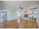 Bright, open living room featuring hardwood floors, a fireplace with built-ins, and a staircase at 8795 E Fairway Woods Cir, North Charleston, SC 29420