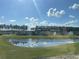 A beautiful view of the homes in this community overlooking a calm pond on a clear and sunny day at 941 Dusk Dr, Summerville, SC 29486