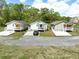 Three quaint homes with colorful doors, each boasting a charming front porch at 0 James Bell Dr, North Charleston, SC 29406