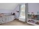 Bright bedroom with a sloped ceiling, a window, neutral walls, and a bed, creating a cozy and inviting space at 104 Queen Mary Ct, Summerville, SC 29485