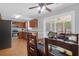 Dining area with a view to a modern kitchen featuring stainless steel appliances and wood cabinets, creating an inviting space at 104 Queen Mary Ct, Summerville, SC 29485