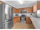 Well-equipped kitchen features stainless steel appliances, light countertops, and wood cabinets, offering style and functionality at 104 Queen Mary Ct, Summerville, SC 29485