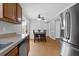 Open kitchen and dining area featuring stainless steel appliances, wood cabinets, and a view to sliding patio doors at 104 Queen Mary Ct, Summerville, SC 29485