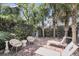 Private backyard oasis features a brick patio with lounge chairs and lush landscaping at 106 Beaufain St, Charleston, SC 29401