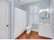 Charming bathroom with white marble countertop, vanity, and framed round mirror at 106 Beaufain St, Charleston, SC 29401