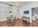 Bright dining room with wood floors, white shutters, and rattan chandelier at 106 Beaufain St, Charleston, SC 29401