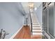 Inviting entryway with a staircase, hardwood floors, and soft blue walls at 106 Beaufain St, Charleston, SC 29401