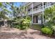 Charming two-story home with a double porch, lush landscaping and brick steps at 106 Beaufain St, Charleston, SC 29401