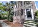 Charming two-story home features front door entrance, steps and landscaped yard at 106 Beaufain St, Charleston, SC 29401