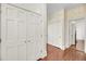 Hallway with hardwood floors, several closets, and patterned wallpaper in bathroom entrance at 106 Beaufain St, Charleston, SC 29401