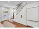 Bright kitchen features stainless steel appliances, white cabinets and staircase at 106 Beaufain St, Charleston, SC 29401