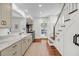 Bright kitchen with stainless steel appliances, marble countertops, wood floors and a staircase at 106 Beaufain St, Charleston, SC 29401
