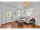 Cozy living room features hardwood floors and sectional seating with natural light at 106 Beaufain St, Charleston, SC 29401