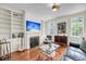Sun-filled living room with a fireplace, built-in shelves, and a stylish decor at 106 Beaufain St, Charleston, SC 29401