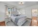 Elegant bedroom with a large bed, soft blue accents, and hardwood flooring at 106 Beaufain St, Charleston, SC 29401