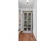 Well-organized pantry with glass-door cabinet and white shelving, offering ample storage space at 106 Beaufain St, Charleston, SC 29401