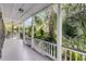 Spacious porch with white railings and columns perfect for enjoying the tropical views at 106 Beaufain St, Charleston, SC 29401