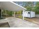 A home's backyard featuring a covered parking area, a small shed, and a grassy yard at 109 Gerideau St, Walterboro, SC 29488