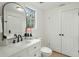 This white bathroom offers an updated vanity with a dark faucet and a white toilet at 109 Gerideau St, Walterboro, SC 29488