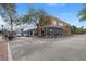 View of a charming brick corner building with large display windows, mature trees and a welcoming storefront at 109 Gerideau St, Walterboro, SC 29488