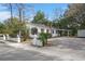 Exterior of a home with white siding, black shutters, large trees and lion statues at 109 Gerideau St, Walterboro, SC 29488