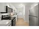 Galley kitchen featuring stainless steel appliances, white cabinetry, and modern fixtures at 109 Gerideau St, Walterboro, SC 29488