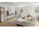 Stylish living room with designer decor, modern furnishings, and bright hardwood floors at 109 Gerideau St, Walterboro, SC 29488