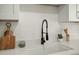 Close up view of a modern kitchen sink with black faucet and white countertops at 109 Gerideau St, Walterboro, SC 29488