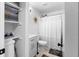 Well-lit bathroom with modern fixtures, shower with curtain, and storage shelves at 109 Sawmill Dr, Summerville, SC 29483