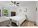 Comfortable bedroom boasts hardwood floors, a ceiling fan, and ample natural light at 109 Sawmill Dr, Summerville, SC 29483