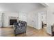 Cozy living room showing a stone fireplace, hardwood floors, and an open doorway to a bedroom at 109 Sawmill Dr, Summerville, SC 29483