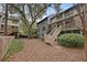 Townhouse backyard with a wooden staircase, screened porch, and mature trees, providing a private outdoor space at 1120 Hidden Cove Dr # I, Mount Pleasant, SC 29464