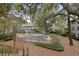 View of the townhouse complex's exterior, featuring a pool and large trees and landscaping at 1120 Hidden Cove Dr # I, Mount Pleasant, SC 29464