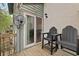 Relaxing patio with two chairs, fan, and sliding glass door, creating an inviting outdoor space at 1120 Hidden Cove Dr # I, Mount Pleasant, SC 29464