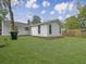 Large, well-manicured backyard and tidy home exterior with new siding and landscaping at 1133 Mount Batten Dr, Hanahan, SC 29410