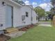 View of home's backyard featuring an access door and new concrete pad for parking at 1133 Mount Batten Dr, Hanahan, SC 29410