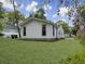 Expansive backyard with lush green lawn and freshly painted home with tidy landscaping at 1133 Mount Batten Dr, Hanahan, SC 29410