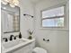 Modern bathroom featuring black fixtures, white vanity, and a bright window for ample natural light at 1133 Mount Batten Dr, Hanahan, SC 29410