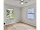 Bright bedroom featuring hardwood floors, ceiling fan, and windows for natural light at 1133 Mount Batten Dr, Hanahan, SC 29410