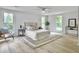 Bright bedroom featuring neutral decor, wood floors, and large windows for ample natural light at 1133 Mount Batten Dr, Hanahan, SC 29410