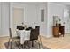 Dining area with a table set for four with modern decor and a view of the hallway at 1133 Mount Batten Dr, Hanahan, SC 29410