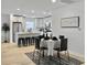 Bright dining room features a table with seating for four, flowing into the bright and modern kitchen at 1133 Mount Batten Dr, Hanahan, SC 29410