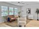 Cozy living room with a comfortable sofa, elegant decor, and natural light from large windows at 1133 Mount Batten Dr, Hanahan, SC 29410
