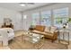 Bright living room with a large window, a comfortable sofa, and stylish decor at 1133 Mount Batten Dr, Hanahan, SC 29410