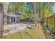 Backyard patio with mature trees and a wooden privacy fence at 115 Foxborough Rd, Goose Creek, SC 29445