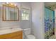 Bathroom with wood vanity, toilet, and shower with colorful curtain at 115 Foxborough Rd, Goose Creek, SC 29445