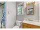 Bright bathroom features a wood framed mirror, window, and tiled shower with stylish curtain at 115 Foxborough Rd, Goose Creek, SC 29445
