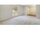 Clean and bright bedroom with carpeted floor, large window, and a glimpse of tile entryway at 115 Foxborough Rd, Goose Creek, SC 29445