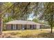 Charming one-story brick home with a well-maintained lawn and mature trees providing shade at 115 Foxborough Rd, Goose Creek, SC 29445